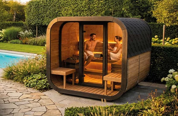 Couple enjoying a sauna by pool.