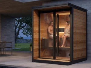 Couple relaxing inside modern outdoor sauna with timber interior and ambient lighting